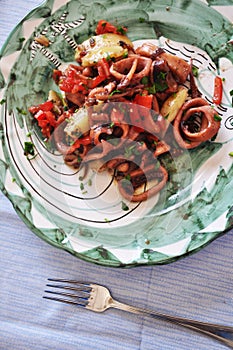 Traditional Italian food Ã¢â¬ÅTotani e patateÃ¢â¬Â with calamari and potatoes photo